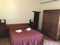 A bed or beds in a room at Agriturismo Diffuso Monte Oliveto Maggiore