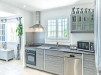 a kitchen with a sink and a microwave at Holiday home in La Roquette sur Siane with furnished garden in La Roquette-sur-Siagne