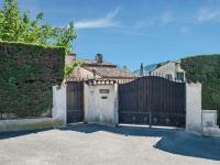 a gate to a house with a wooden fence at Holiday home in La Roquette sur Siane with furnished garden in La Roquette-sur-Siagne