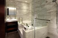 a bathroom with a shower and a tub and a sink at Leofoo Residences in Taipei