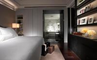 a bedroom with a white bed and a bathroom at Leofoo Residences in Taipei