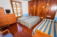 Postel nebo postele na pokoji v ubytování Hotel Castillo de Gauzón