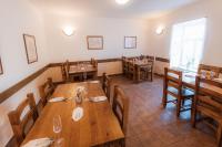 uma sala de jantar com mesas e cadeiras de madeira em Hotel Pod Zámkem em Vranov nad Dyjí