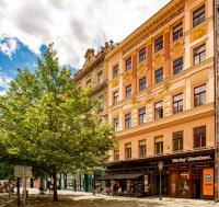 a large orange building with a tree in front of it at Residence St Havel Prague Old Town in Prague