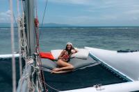 a woman sitting on the back of a boat at Sarikantang Resort & Spa, Koh Phangan in Haad Rin