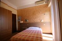 A bed or beds in a room at Albergo Centopini