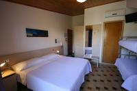 A bed or beds in a room at Albergo Centopini