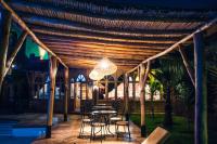 a patio with a table and chairs under a wooden pergola at Palais D'Ouzoud in Azilal