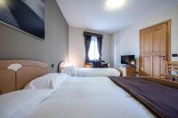 Łóżko lub łóżka w pokoju w obiekcie Marangon Apartments