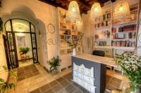 a library with two chandeliers and bookshelves at La Casa de la Favorita in Tarifa