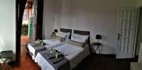 A bed or beds in a room at EMI's Guest House