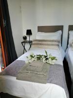 A bed or beds in a room at EMI's Guest House