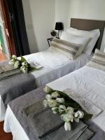 A bed or beds in a room at EMI's Guest House