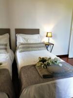 A bed or beds in a room at EMI's Guest House