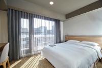 a bedroom with a large bed and a large window at Simple + Hotel in Taipei