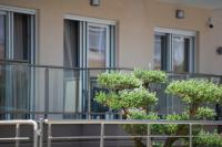 two trees in front of a building at Crist Luxury Apartments in Nea Potidaea