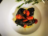 a white plate with a dish of food on it at Garda Relais Antica Romelia in Montichiari