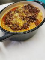 a pan filled with food sitting on a table at Garda Relais Antica Romelia in Montichiari