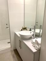 a white bathroom with a sink and a mirror at Appartement Hyper-centre Colmar in Colmar