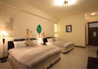 a hotel room with two beds in a room at Green Window Homestay in Hualien City