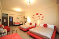 a bedroom with two beds with hearts on the wall at Green Window Homestay in Hualien City
