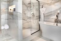 a bathroom with a shower and a tub and a sink at Hôtel Richer De Belleval - Relais &amp; Châteaux in Montpellier