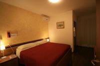 A bed or beds in a room at Albergo Centopini