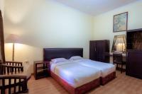 Hotel Mahkota Plengkung by ecommercelokaにあるベッド