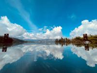 a reflection of the sky and clouds in the water at Ailiga Travel Villa in Ren&#39;ai