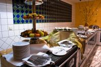 a kitchen with plates and fruit on a counter at Calimbra Wellness Hotel Superior in Miskolctapolca