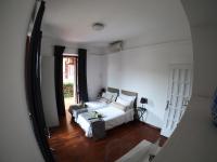 A bed or beds in a room at EMI's Guest House
