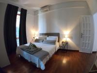 A bed or beds in a room at EMI's Guest House