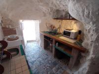 a kitchen with a counter with a microwave on it at Casa Cueva “La Estrella” in Granada