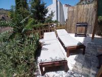 a couple of benches sitting in a yard at Casa Cueva “La Estrella” in Granada