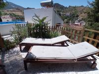 a couple of lounge chairs on a patio at Casa Cueva “La Estrella” in Granada