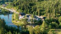 an aerial view of a house on an island in a river at Aries Hotel & SPA Wisła in Wisła