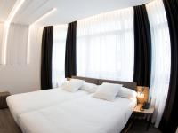 Cama o camas de una habitación en Hotel Lux Santiago