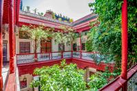 an old house with a balcony and plants at Riad Chorfa in Marrakesh