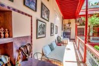 a living room with a couch and a balcony at Riad Chorfa in Marrakesh