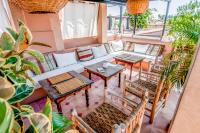 a balcony with tables and chairs and plants at Riad Chorfa in Marrakesh