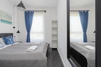 Posteľ alebo postele v izbe v ubytovaní Nowa Letnica Apartments by Noclegi Renters