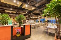 a restaurant with tables and chairs and potted plants at Villa del Palmar Cancun Luxury Beach Resort & Spa in Cancún