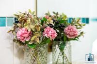 two vases filled with pink flowers on a table at City View Apartments Birmingham City Centre in Birmingham