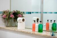 a bathroom counter with toiletries and a mirror at City View Apartments Birmingham City Centre in Birmingham