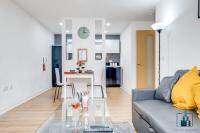 a living room with a couch and a glass table at City View Apartments Birmingham City Centre in Birmingham