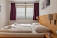 Łóżko lub łóżka w pokoju w obiekcie Fourteen Zell am See S&P by All in One Apartments