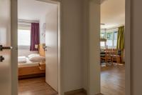 Łóżko lub łóżka w pokoju w obiekcie Fourteen Zell am See S&P by All in One Apartments