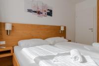 Łóżko lub łóżka w pokoju w obiekcie Fourteen Zell am See S&P by All in One Apartments