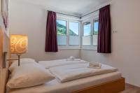 Łóżko lub łóżka w pokoju w obiekcie Fourteen Zell am See S&P by All in One Apartments