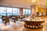 Hotel Ichibata في ماتسو: مطعم به طاولات وكراسي ونوافذ كبيرة